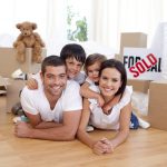 Happy family lying on floor after buying new house